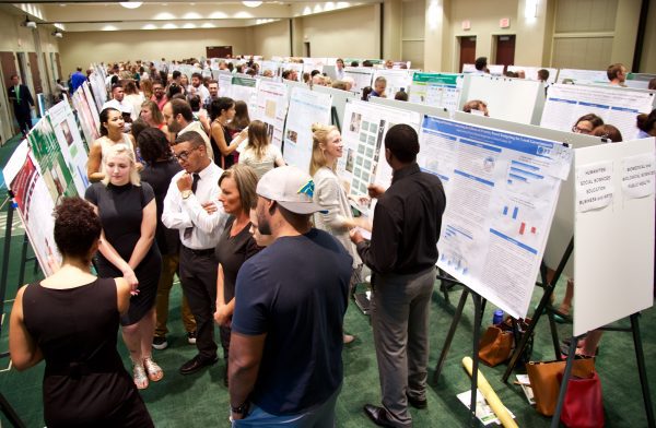 students with their research posters - crowd shot