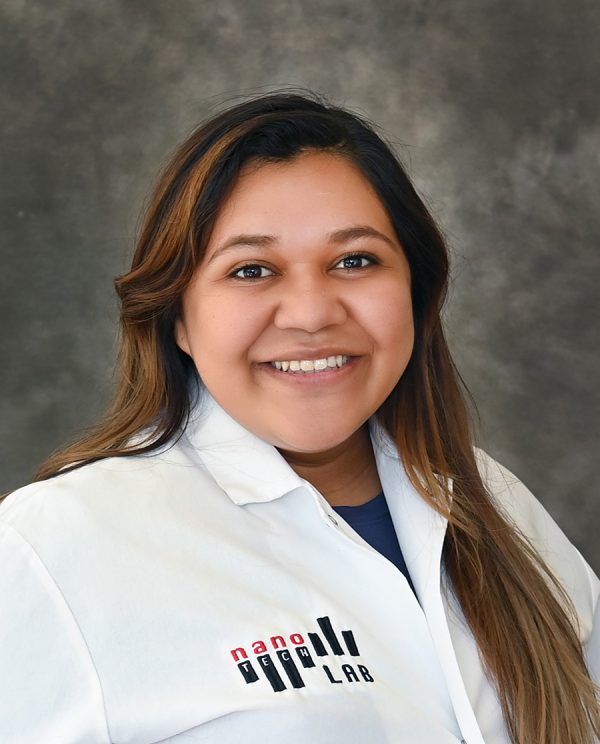 Yelixza Avila smiles while wearing her Nano Tech lab coat.